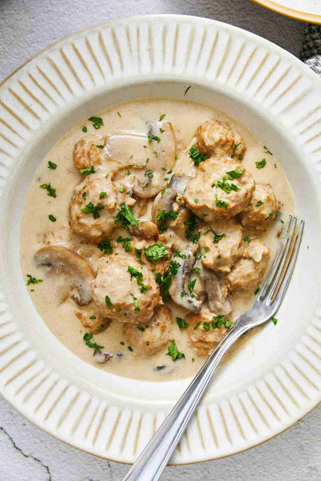 Slow cooker crock filled with creamy mushroom gravy and Swedish party meatballs