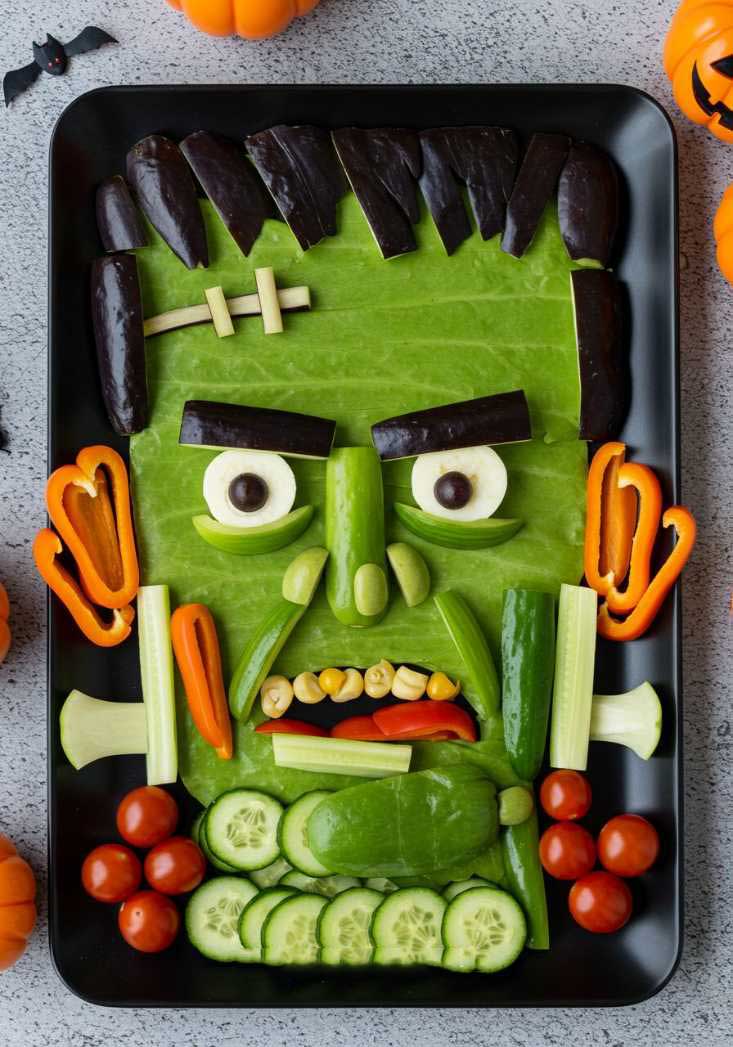 Carrot and cucumber sticks arranged to look like a Frankenstein monster face