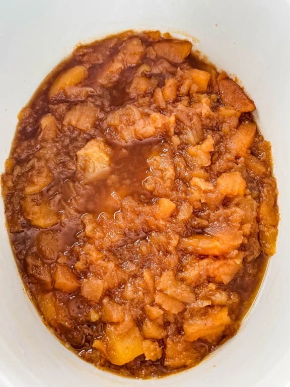 Classic homemade apple butter glistening in a mason jar, caramel, cinnamon, cloves aroma