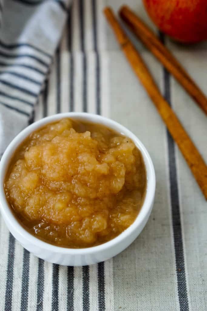 Warm, caramelized apple butter with cinnamon and cloves, served in a mason jar