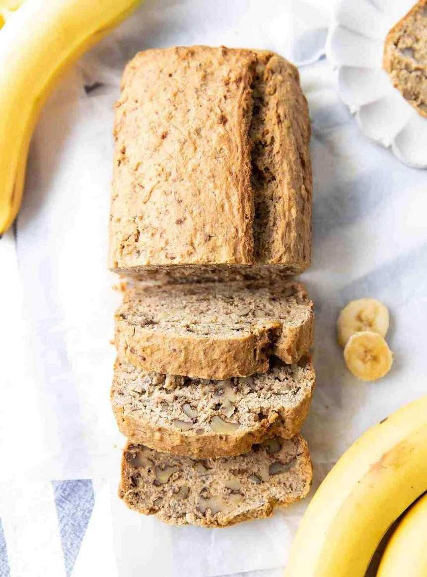 Crusty gluten‑free banana bread topped with toasted nuts and a soft interior