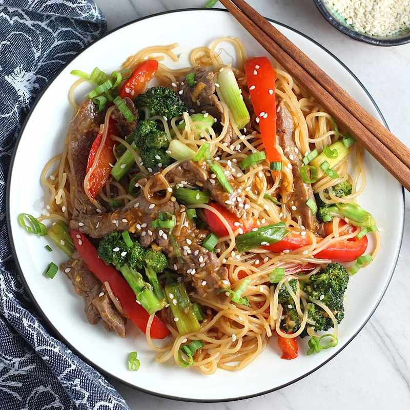 Overhead view of beef and broccoli noodles on a plate, featuring tender beef, crisp broccoli, and glossy sauce