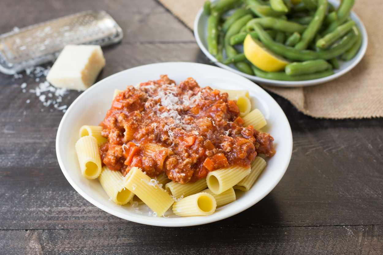 Savory turkey bolognese simmering in a pan, fragrant tomato sauce with herbs.