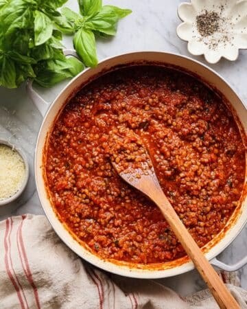 Lentil bolognese mimics beef bolognese, topped with parmesan, fresh basil, rich tomato sauce, pasta