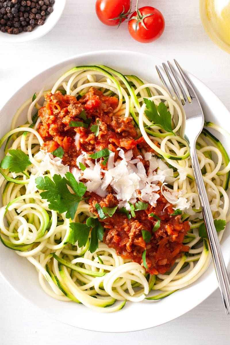 Zucchini noodles tossed in hearty beef bolognese, fresh basil, and parmesan