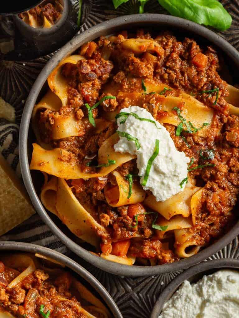 Creamy bolognese with spinach, beef, parmesan, fresh basil, rich tomato sauce, and pasta.