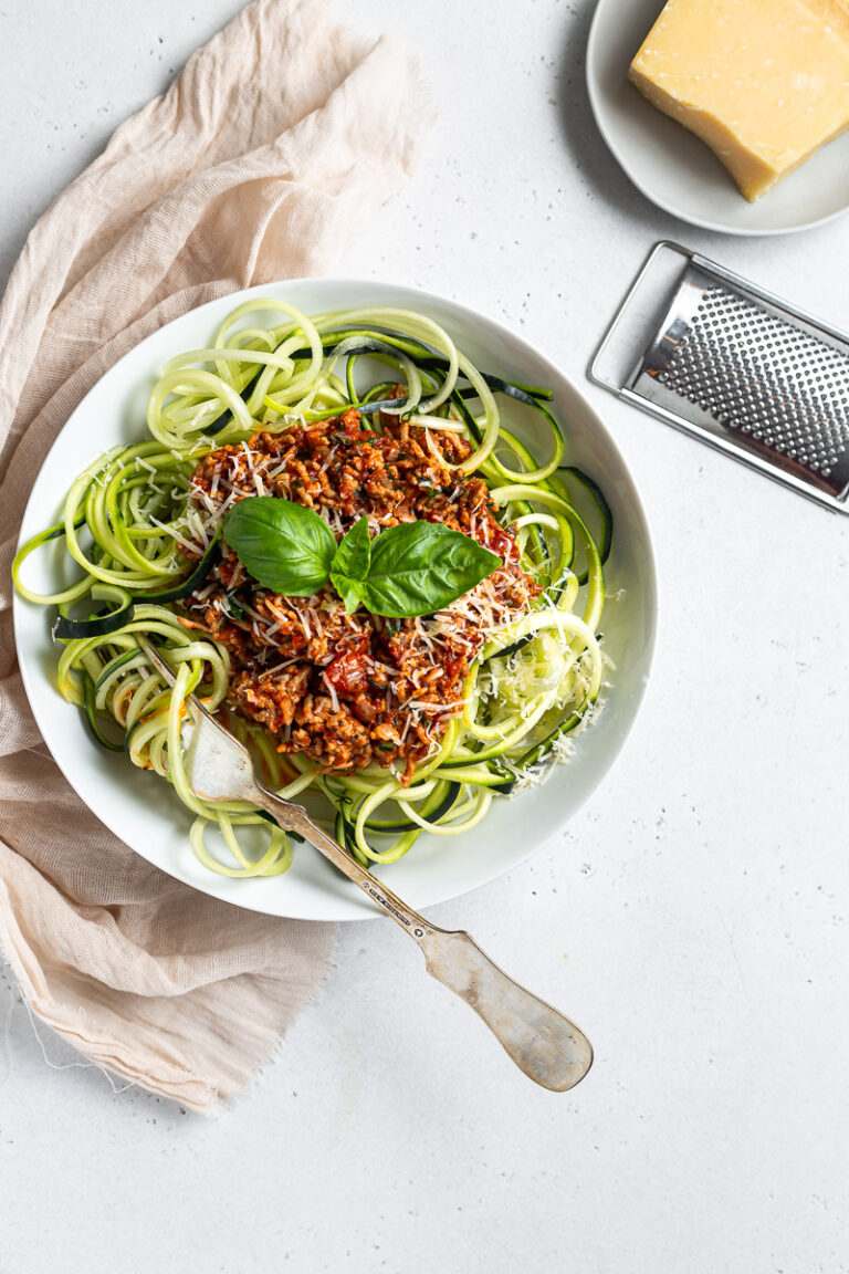 Low‑carb bolognese with beef, parmesan, fresh basil, rich tomato sauce, and pasta substitute.