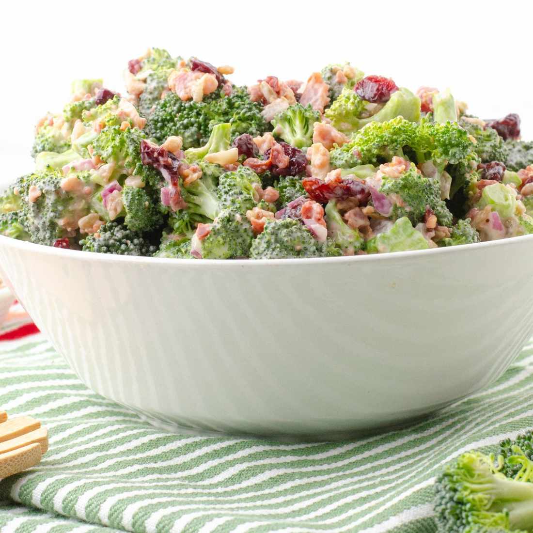 Classic broccoli salad with crunchy peanuts, sweet cranberries, sharp cheddar, creamy ranch dressing, fresh cilantro