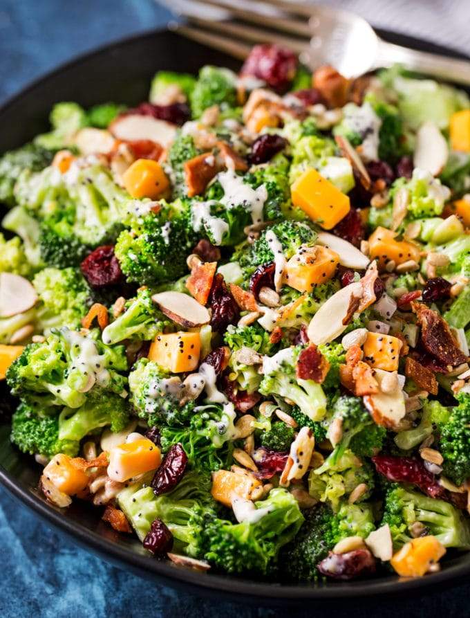 Classic broccoli salad with crisp florets, cheddar cheese, bacon bits, raisins, and tangy dressing