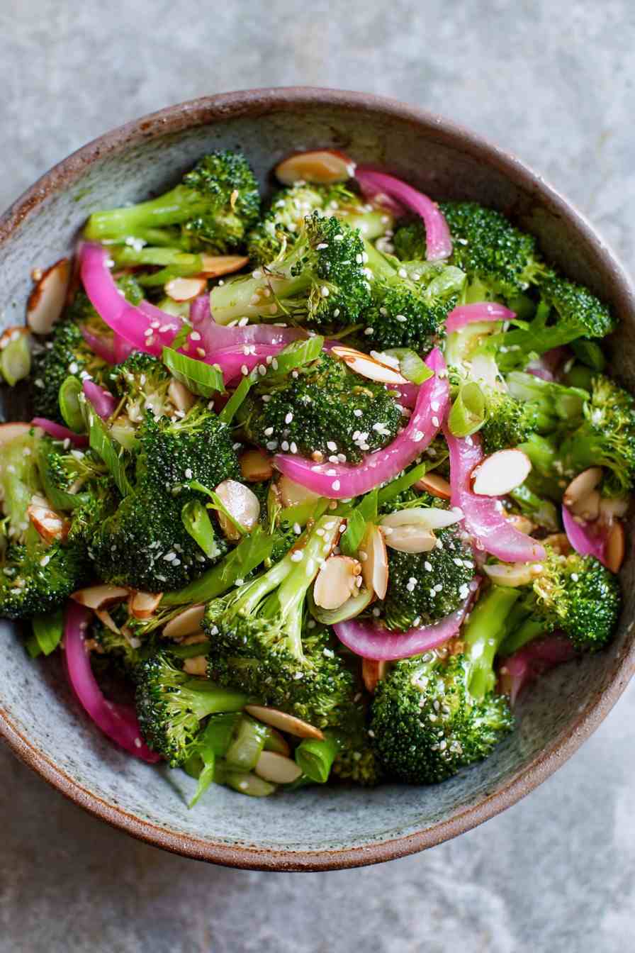 Asian broccoli salad with sesame oil, soy sauce, crispy shallots, toasted peanuts, and julienned carrots
