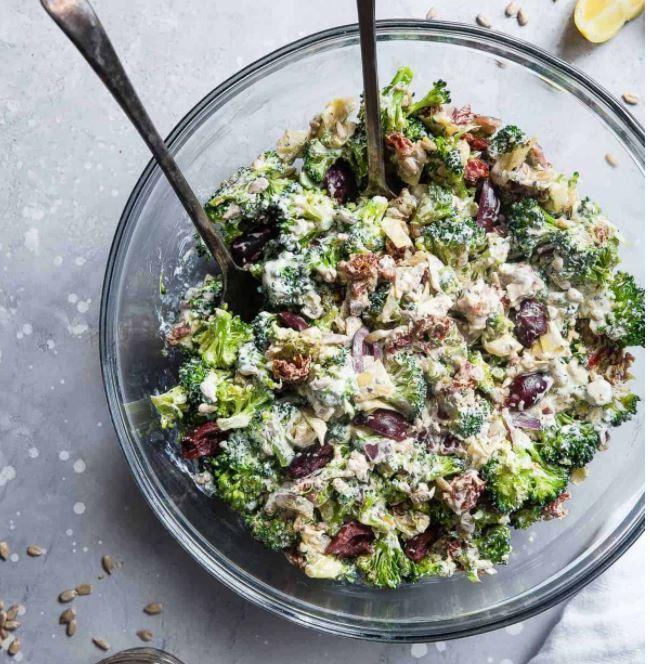 Mediterranean broccoli salad featuring crisp florets, sun‑dried tomatoes, feta, basil, and a garlic‑lemon dressing