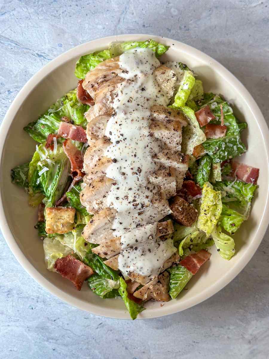 Blackened cajun chicken caesar salad with spicy sliced chicken breast crisp romaine and creamy dressing