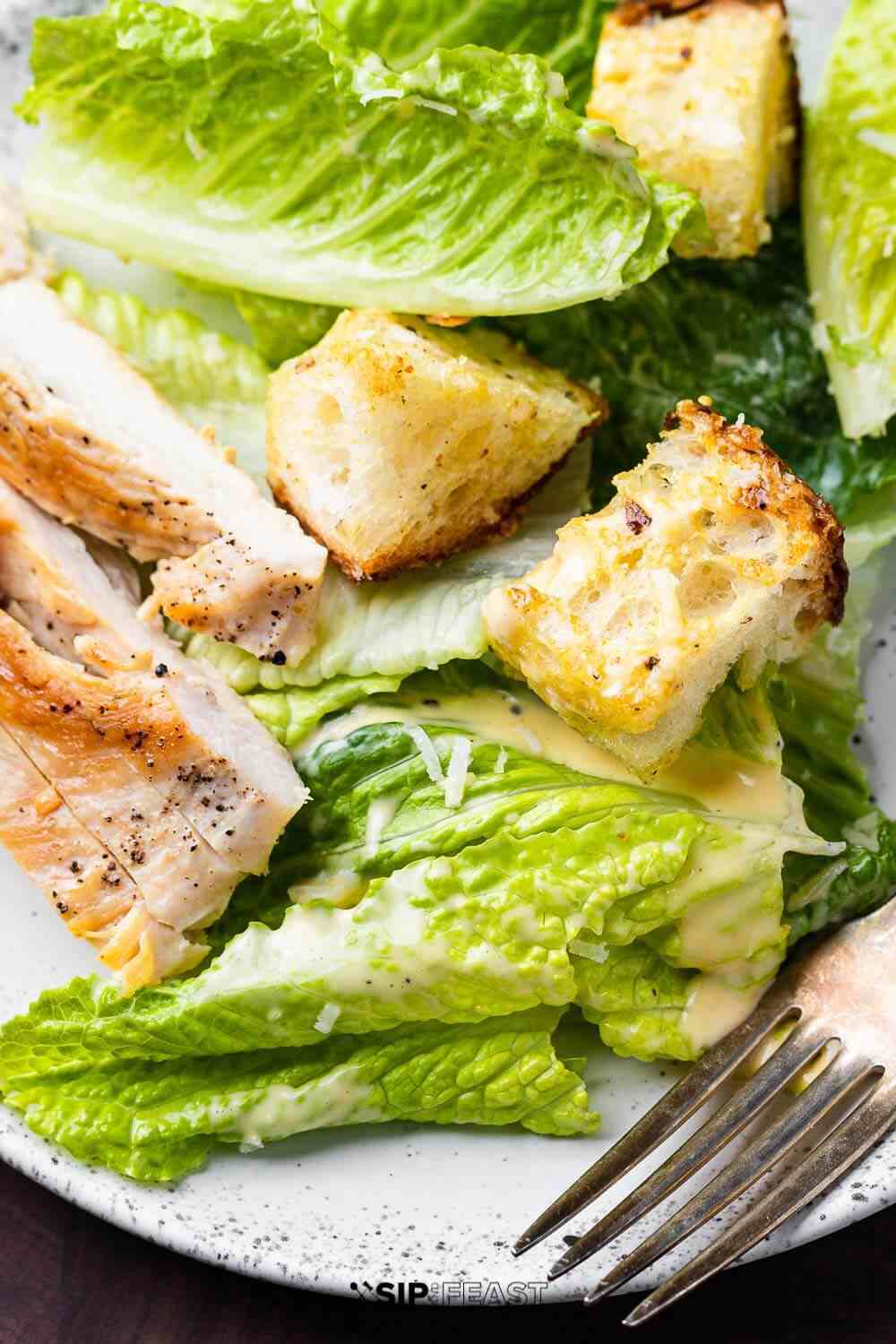 Balsamic glazed chicken caesar salad with sliced grilled chicken breasts crisp romaine and parmesan