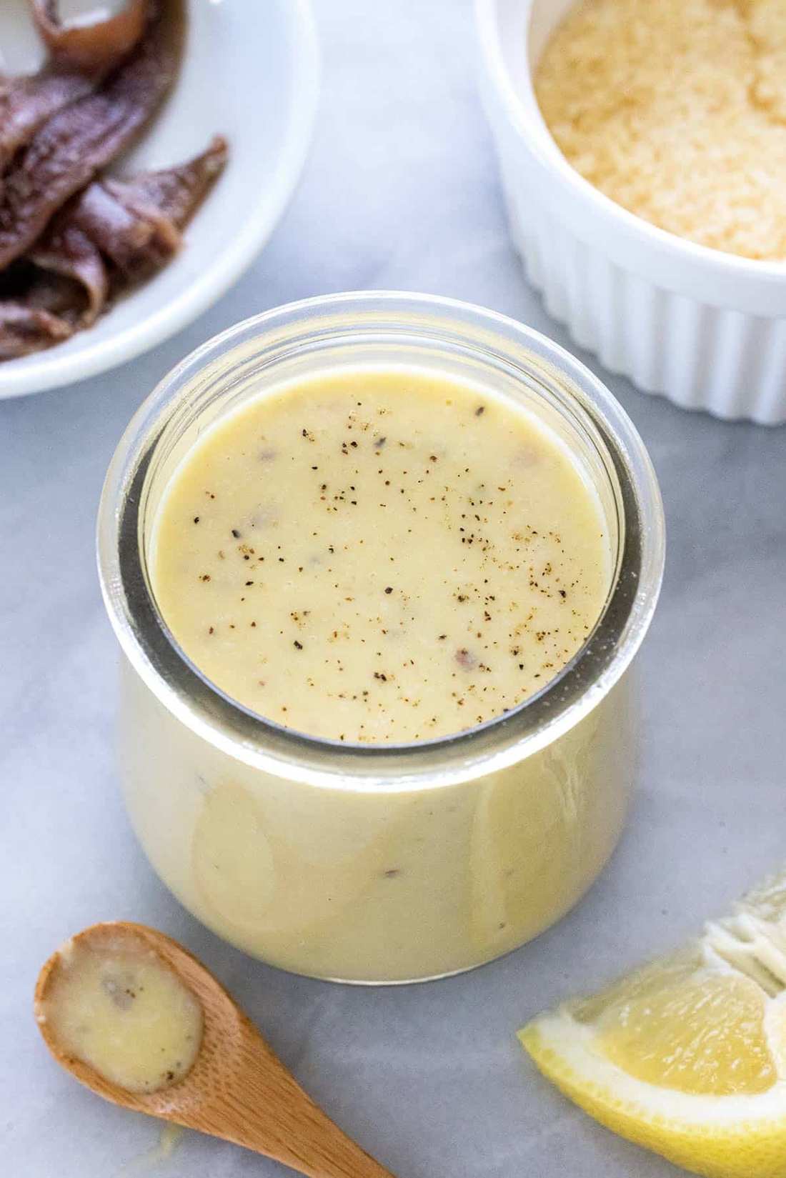 Velvety roasted garlic and cracked peppercorn caesar dressing served in a small glass pitcher