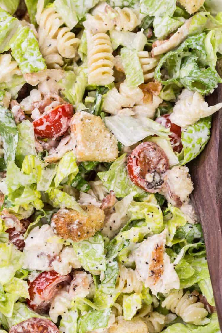 Chilled chicken caesar pasta salad with crisp romaine, crunchy croutons, shaved parmesan, creamy dressing.