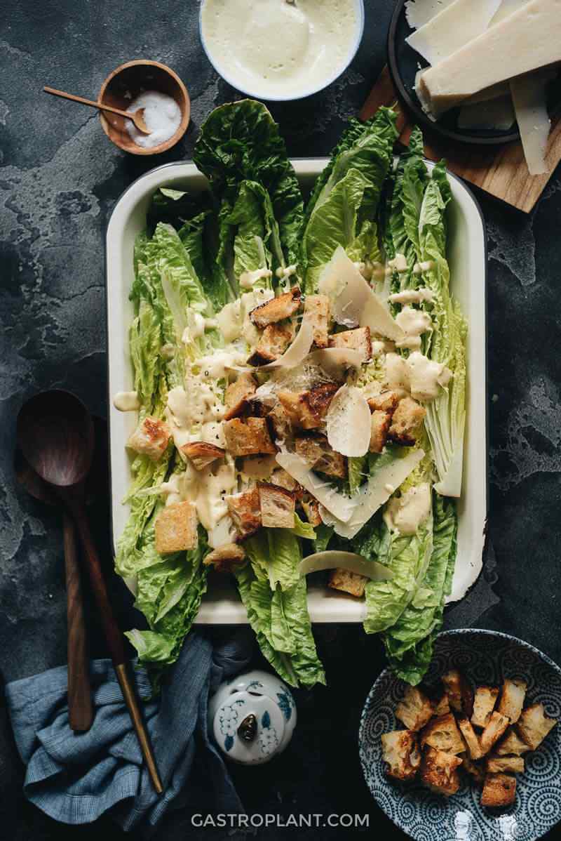 Plant-based vegan caesar salad with crisp romaine, crunchy croutons, shaved parmesan, and creamy dressing.