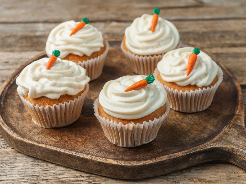 Bite‑size carrot cake cupcakes with a swirl of cream cheese frosting and a sprinkle of cinnamon sugar