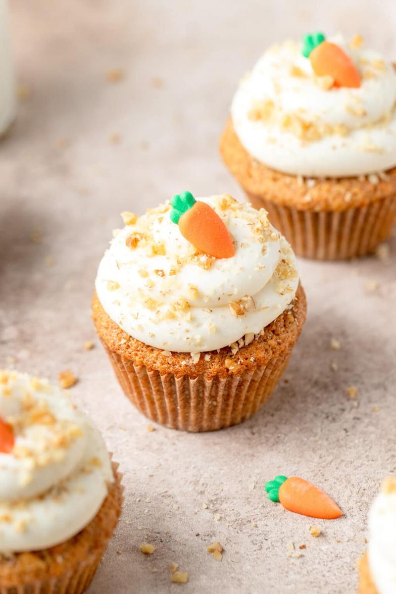 Moist carrot cupcake topped with silky brown butter cream cheese frosting and a drizzle of caramel