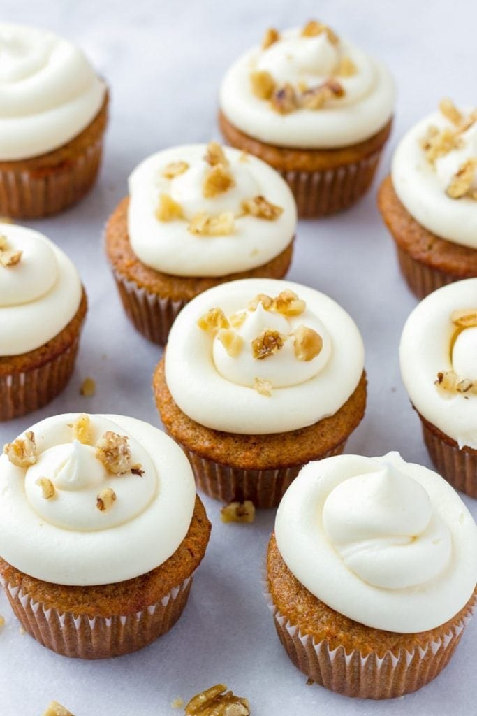 Bakery‑style carrot cupcake with moist spiced crumb, rich cream cheese frosting, and a drizzle of caramel