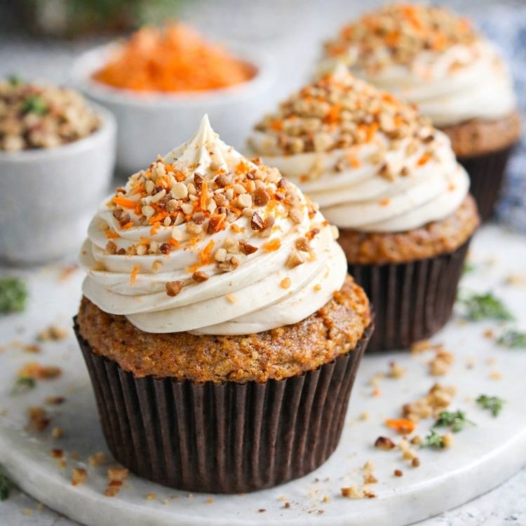 Vegan carrot cupcake packed with pineapple chunks, moist spiced crumb, and dairy‑free cream cheese frosting