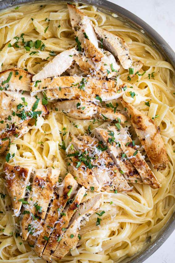 Classic fettuccine chicken alfredo with tender chicken and silky parmesan cream sauce on pasta.