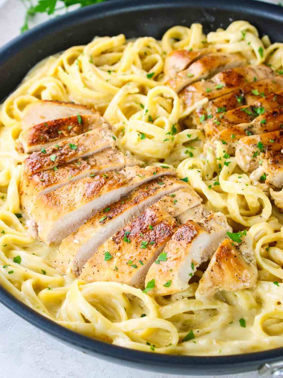 Classic fettuccine chicken alfredo plate featuring tender chicken in a silky parmesan cream sauce.