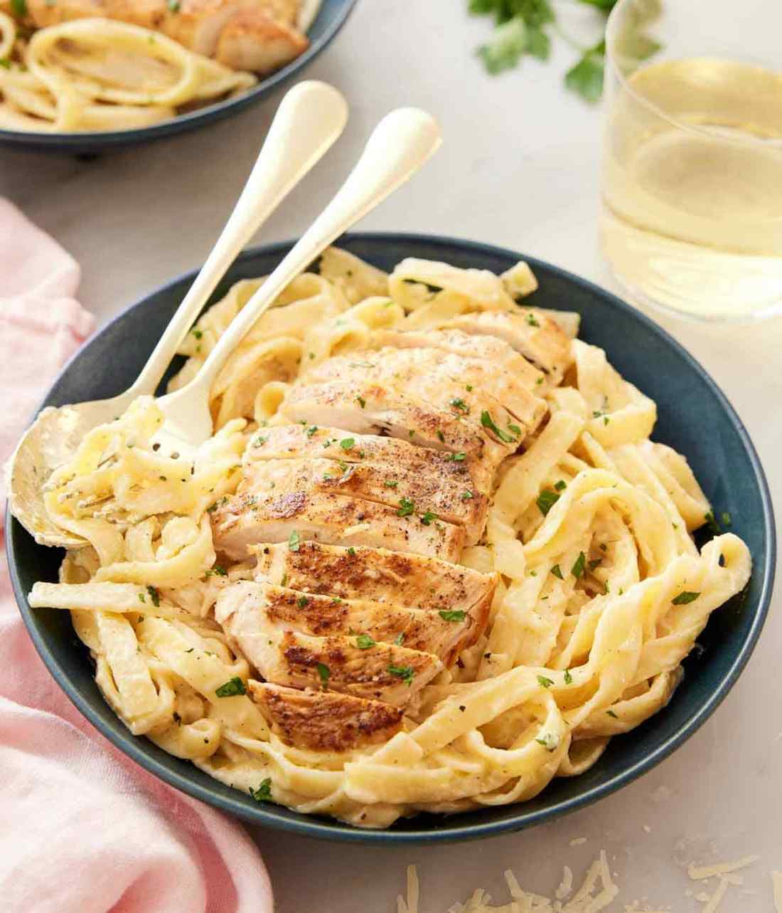Tender chicken cubes nestled in a glossy parmesan cream sauce, hugging fettuccine ribbons.