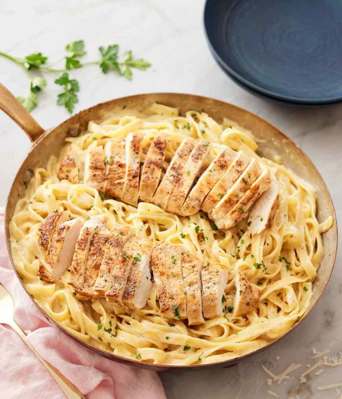 Silky fettuccine with succulent chicken in parmesan cream sauce, finished with fresh herbs