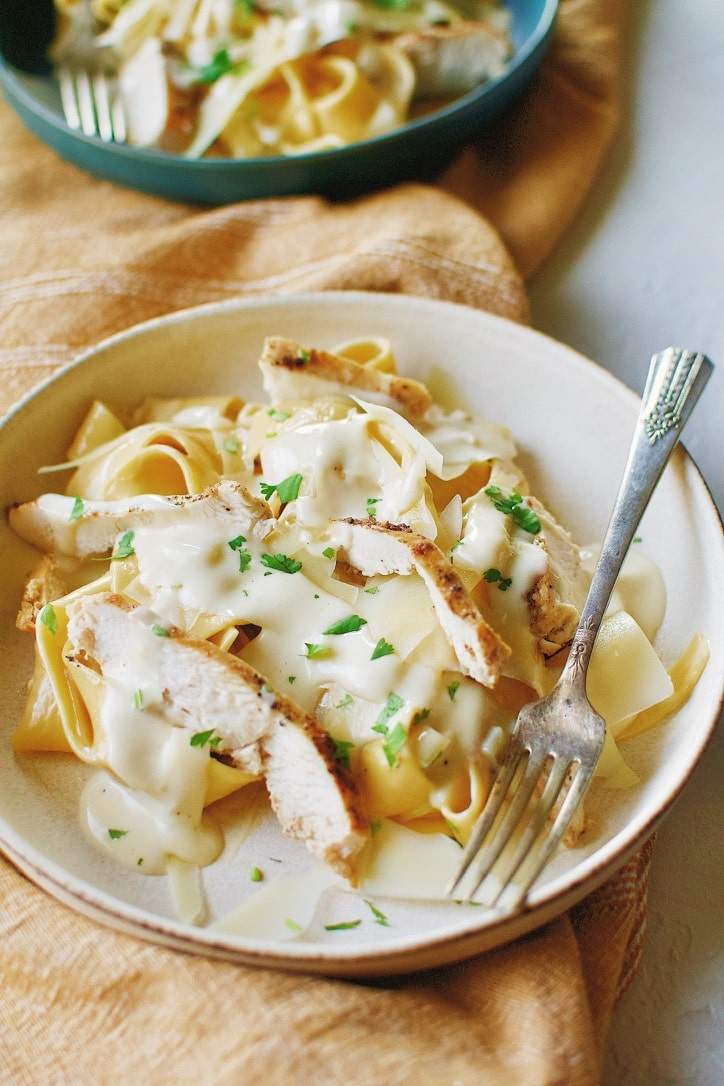 Classic fettuccine chicken alfredo featuring tender chicken, silky parmesan cream sauce, and glossy fettuccine strands