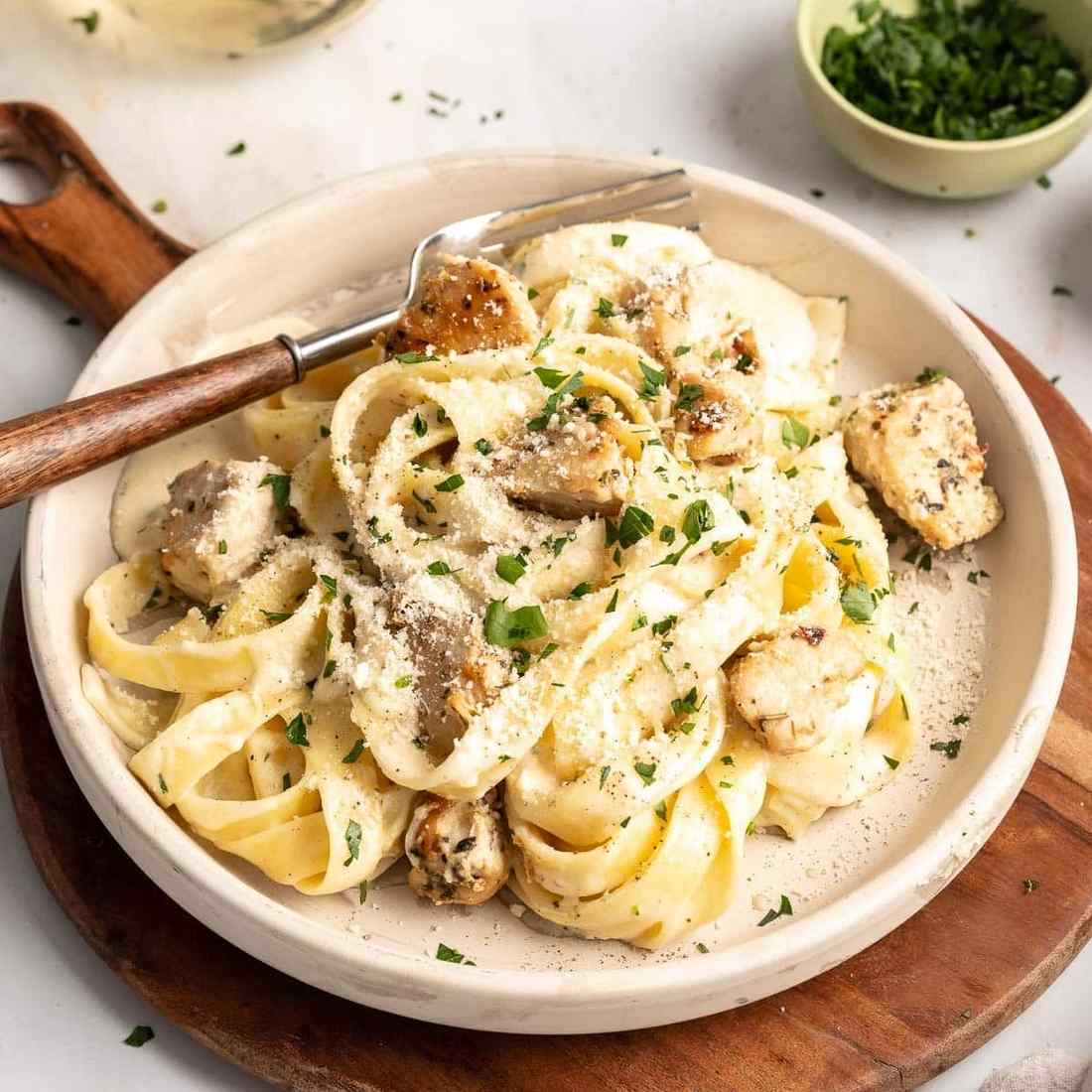 Creamy gluten-free chicken alfredo with tender grilled chicken and silky parmesan cream sauce over fettuccine.