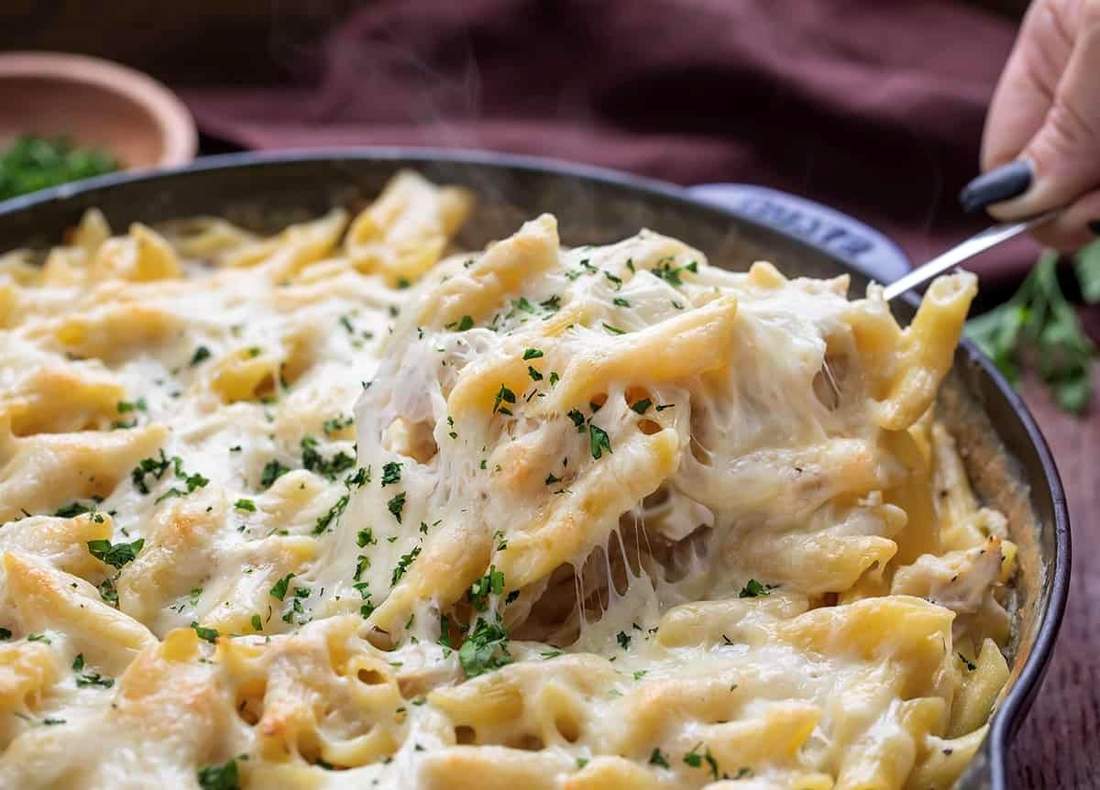 Gluten-free chicken alfredo featuring tender chicken tossed in silky parmesan cream sauce over fettuccine.
