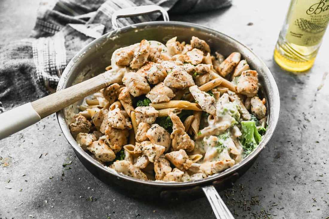 Chicken alfredo with broccoli featuring tender chicken and silky parmesan cream sauce with fettuccine.