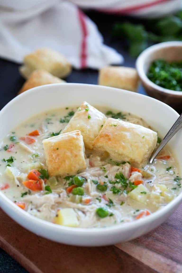 Classic creamy chicken pot pie soup with tender chicken, carrots, peas, potatoes, and a flaky pastry crust topping