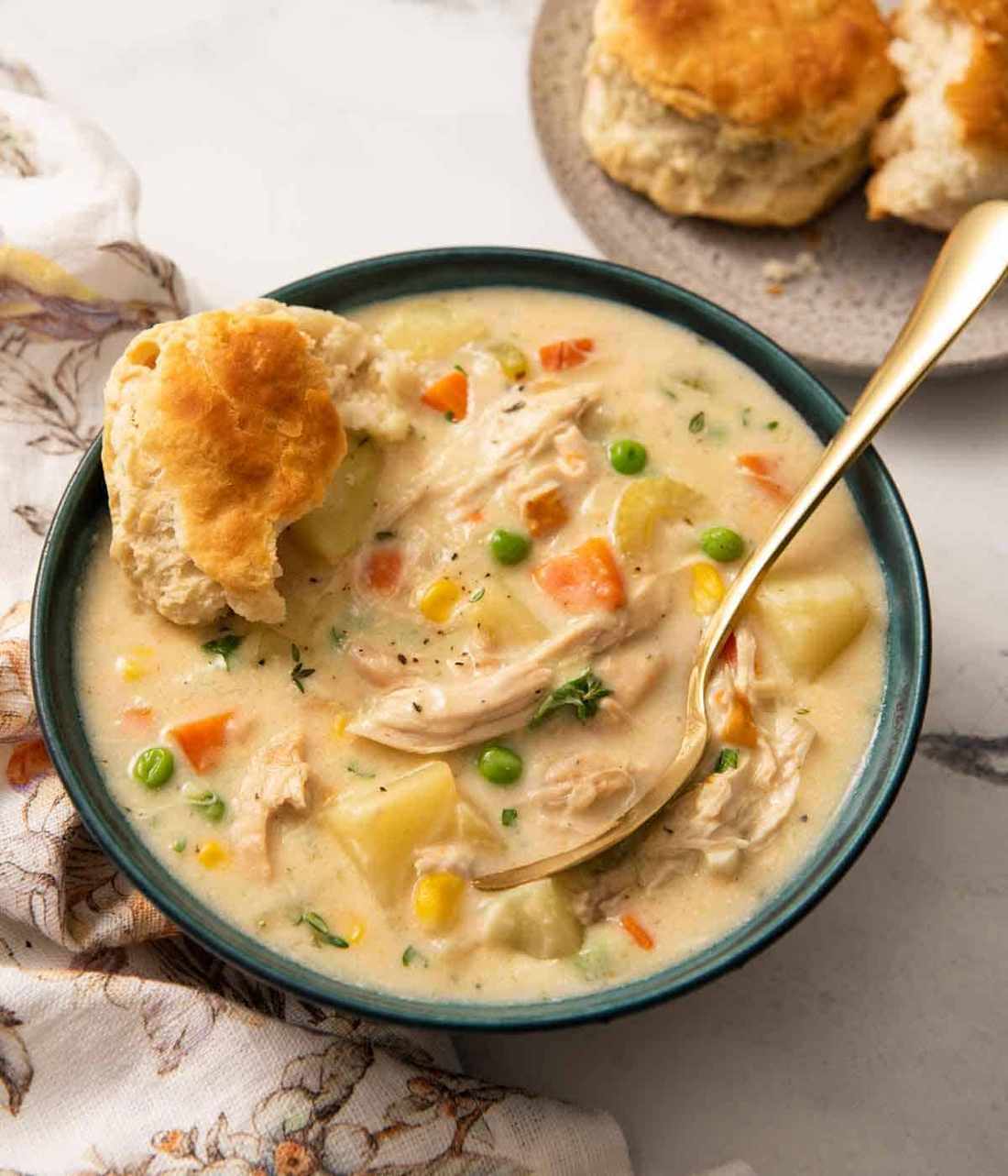 Creamy chicken pot pie soup with flaky puff‑pastry topping, chicken, peas, carrots, and potatoes
