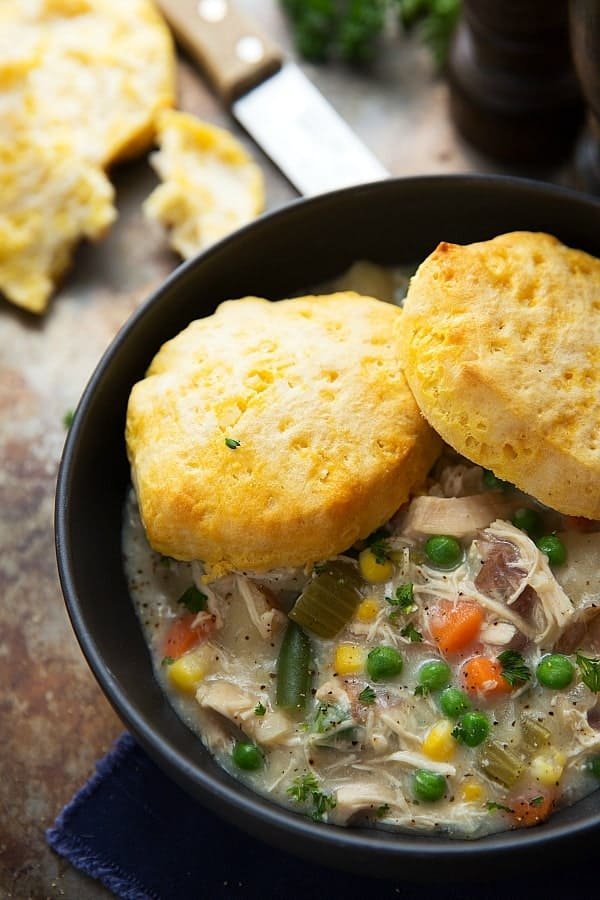 Creamy chicken pot pie soup featuring garlic‑Parmesan puff topping, peas, carrots, potatoes