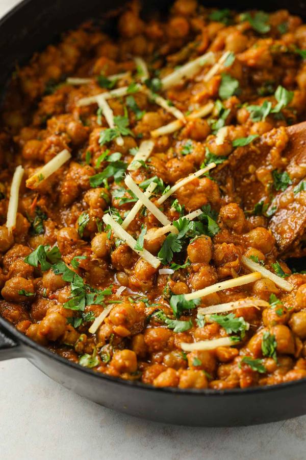 Hearty chickpea curry with rich tomato sauce, aromatic spices, and fresh cilantro, served over steaming basmati rice.