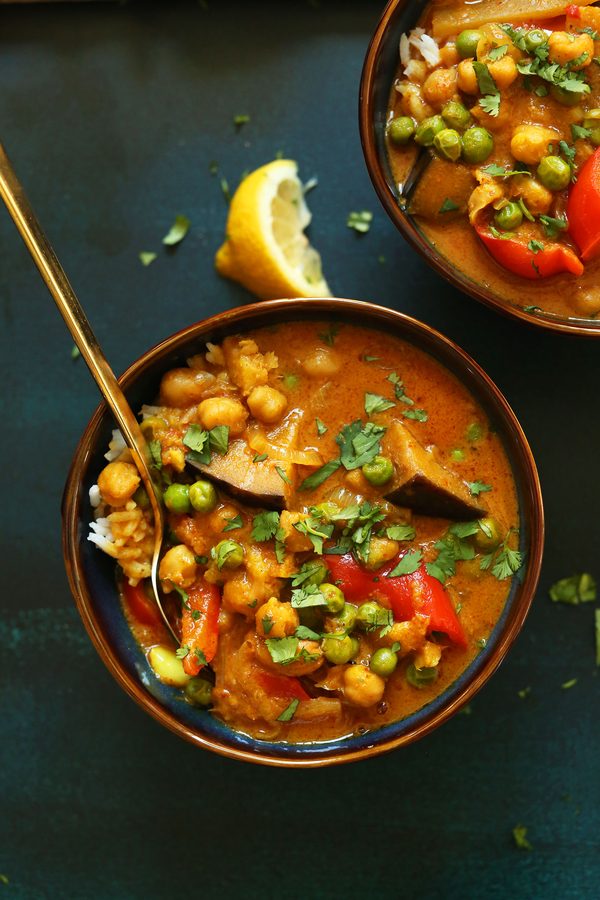 Creamy coconut chickpea curry with a golden sauce, fresh cilantro, and a lime twist, served over basmati rice.