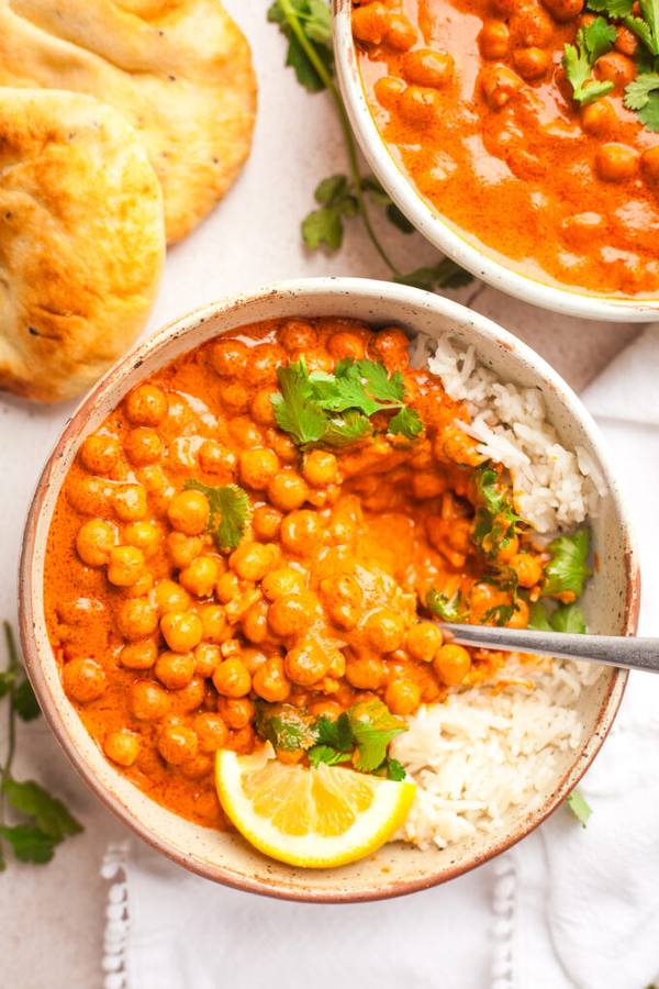 Warm slow cooker chickpea curry with sweet potatoes in golden spice sauce over basmati rice.