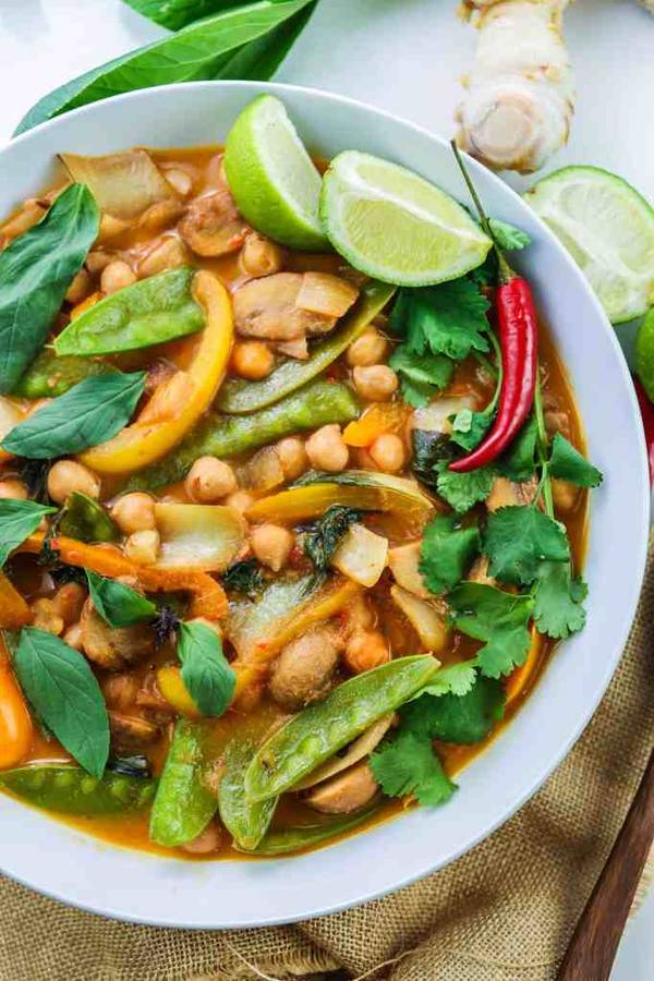 Colorful Thai red chickpea curry simmered with green snap peas and warm spices over fluffy rice.