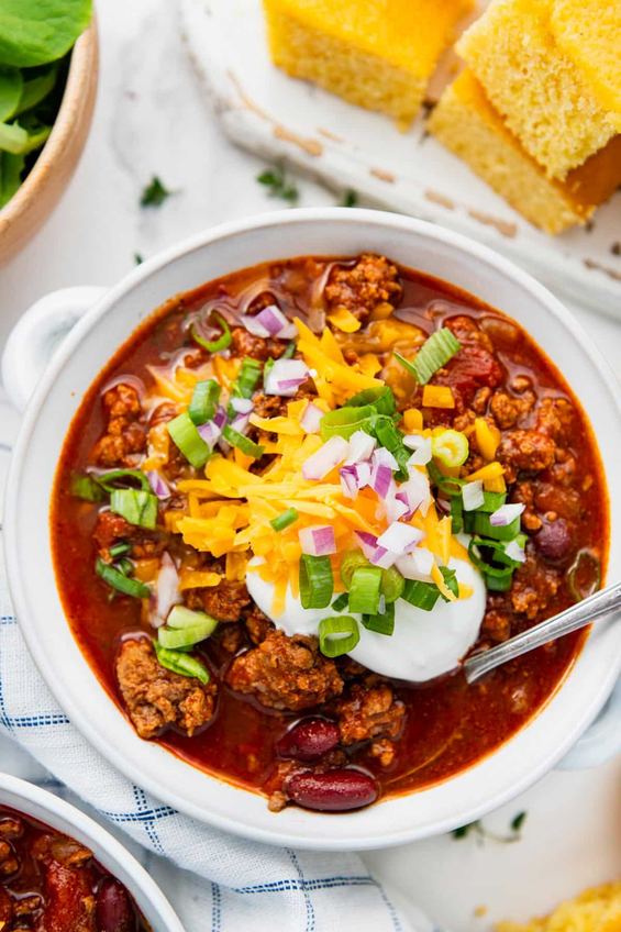 Fire-roasted poblano beef chili garnished with fresh cilantro and pickled jalapeños