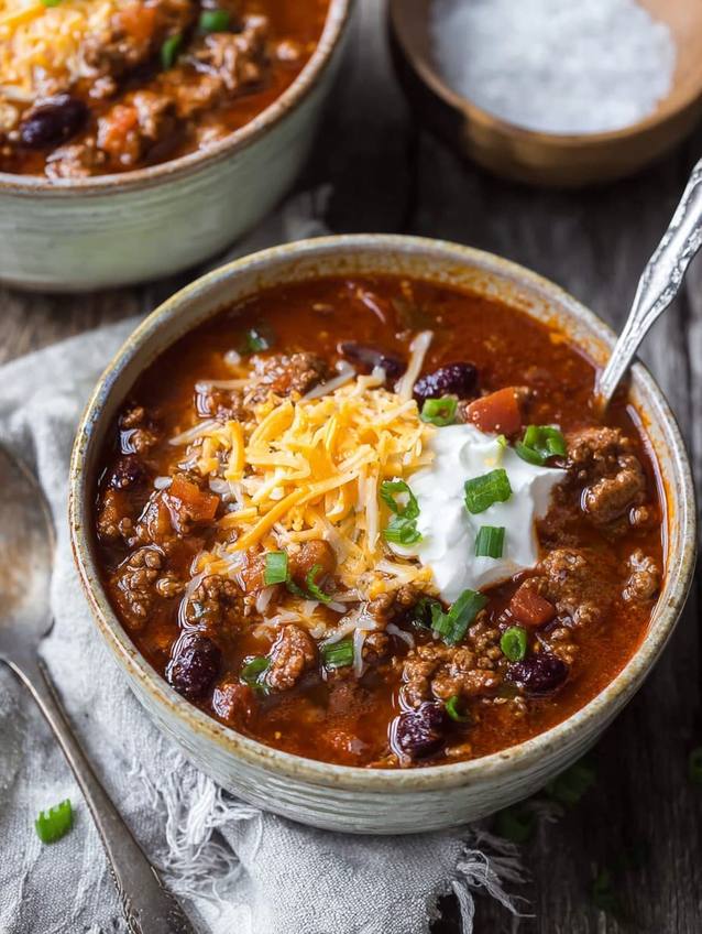 Thick chunky Texas style beef chili served in a rustic bowl with jalapeño slices