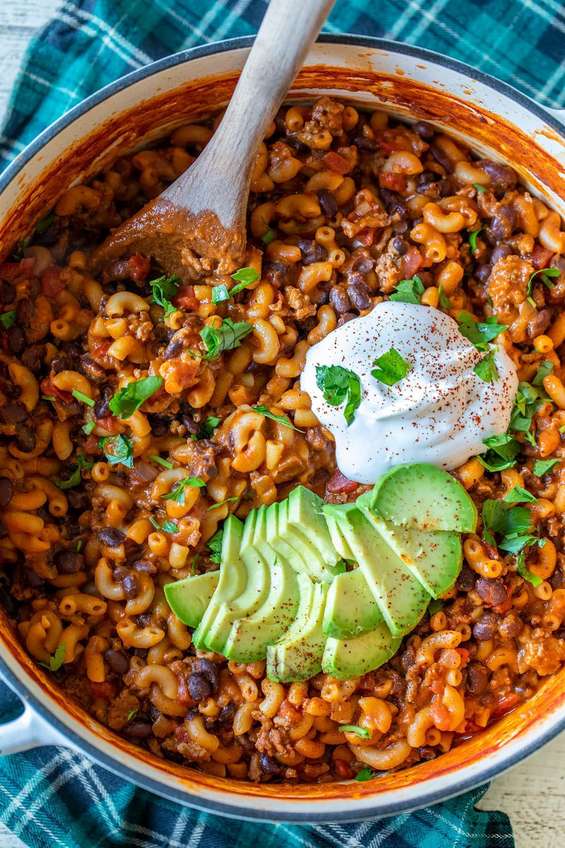 One pot cheddar chili mac with elbow macaroni, ground beef, and bubbling melted cheese
