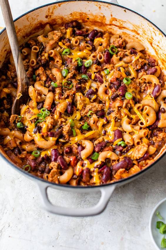Warm bowl of turkey chili with beans, melted cheese, sour cream, jalapenos, comforting aroma