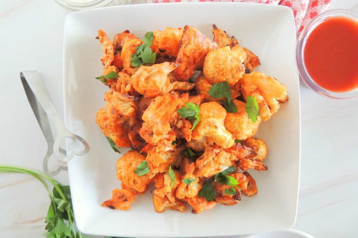Golden cauliflower florets tossed in spicy buffalo sauce, served with celery sticks and ranch dip
