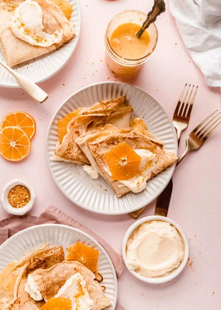 Delicate crepes filled with creamy ricotta, drizzled with orange‑citrus sauce