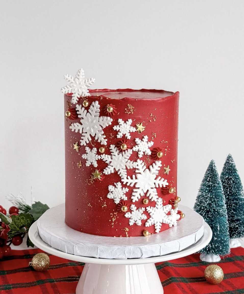 Deep red velvet cake with cascading white snowflake fondant and shimmer dust