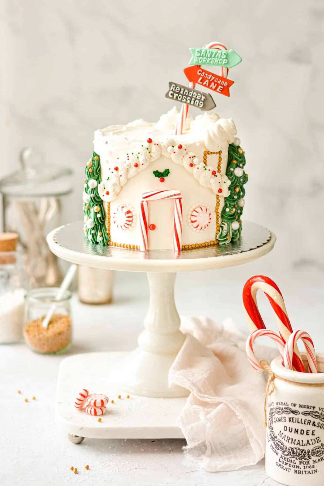 Spiced gingerbread cake shaped like a house, decorated with candy windows and icing roof
