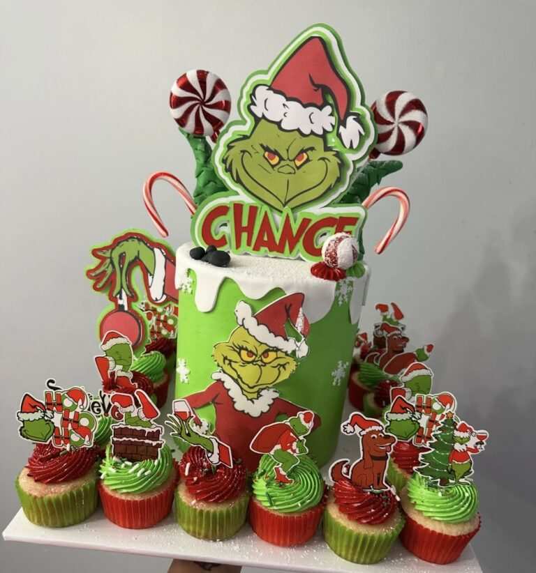 Green frosted cupcakes with Grinch faces and tiny candy cane accents