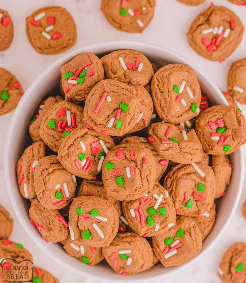 Small round cookies rolled in cinnamon sugar with a soft, chewy center on a festive napkin.
