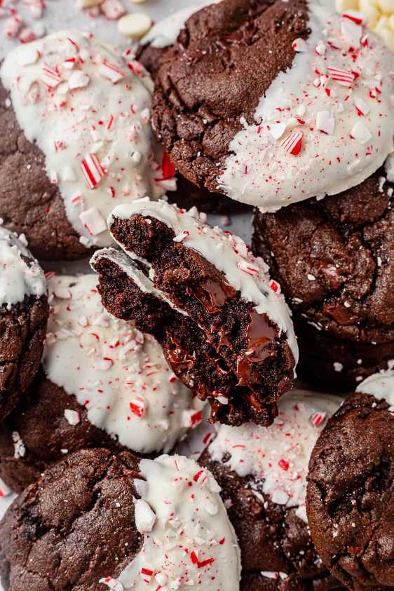 Thick chocolate cookies with crushed peppermint and white chocolate chunks on a festive platter.